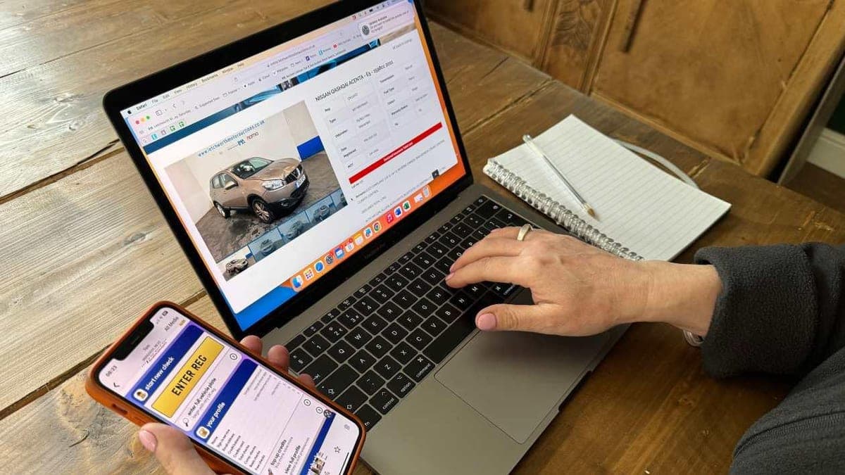 Car owner searching for vehicle service records on a laptop